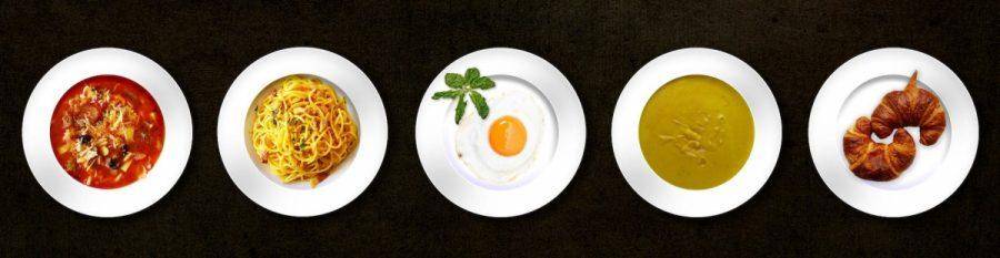 five white plates with different kinds of dishes